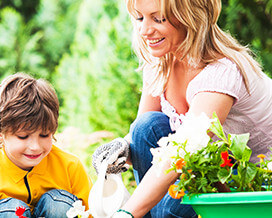 Mother Planting Flowers with Son